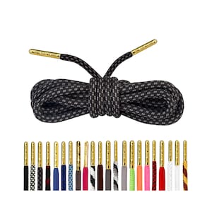May include: Black and grey shoelaces with gold aglets. The shoelaces are made of a braided material and are 45 inches long. The aglets are made of metal and have a gold finish.