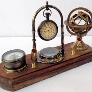 Antique brass table top clock with pen holder compass armillary sphere globe clock desk top wooden base image 2