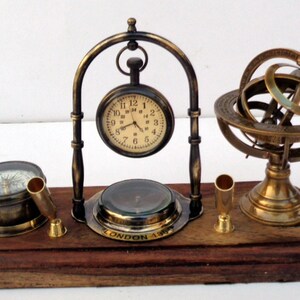 Antique brass table top clock with pen holder compass armillary sphere globe clock desk top wooden base image 1