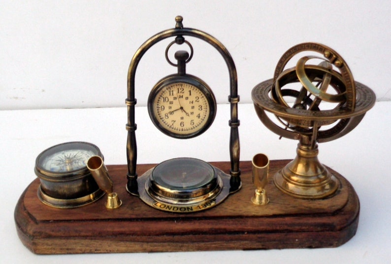 Antique brass table top clock with pen holder compass armillary sphere globe clock desk top wooden base image 1