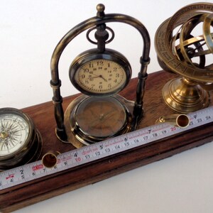 Antique brass table top clock with pen holder compass armillary sphere globe clock desk top wooden base image 5