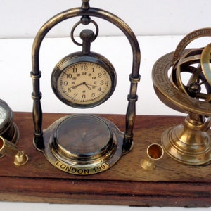 Antique brass table top clock with pen holder compass armillary sphere globe clock desk top wooden base image 3