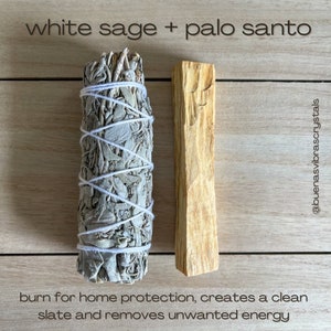 May include: White sage smudge stick and palo santo stick on a wooden surface. The text "white sage + palo santo" is above the sticks. The text "burn for home protection, creates a clean slate and removes unwanted energy" is below the sticks. The text "@buenasvibrascrystals" is on the right side of the image.
