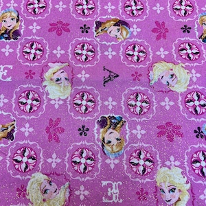 May include: Pink fabric with a repeating pattern of a white and black tile design. The fabric features a glittery finish and a repeating image of a blonde haired girl with a blue dress.