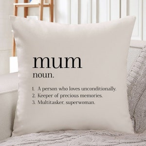 May include: White cushion with black text that reads "mum noun. 1. A person who loves unconditionally. 2. Keeper of precious memories. 3. Multitasker, superwoman."