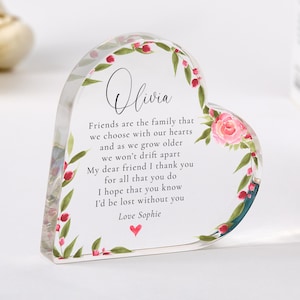 May include: A heart-shaped clear acrylic keepsake with floral and leaf accents. The keepsake features the name "Olivia" and a poem about friendship. The poem is signed "Love Sophie" with a small red heart.