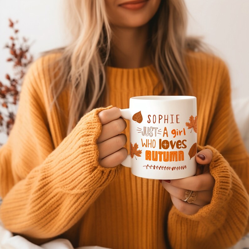 May include: White ceramic mug with a personalized message that reads "Sophie Just A Girl Who Loves Autumn" with orange and brown fall leaves and a star design.