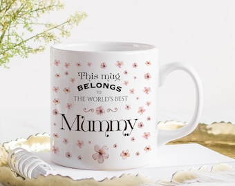 May include: White ceramic mug with a pink floral design and the text "This mug belongs to the world's best Mummy".