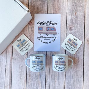 May include: A gift set featuring a white box, two white enamel mugs, two coasters, and a card, all with a caravan design. The mugs and coasters are personalized with names and the phrase "Home is where we park it."