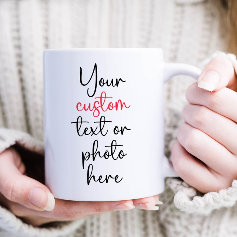 May include: White ceramic mug with a black and red inscription that reads "Your custom text or photo here".