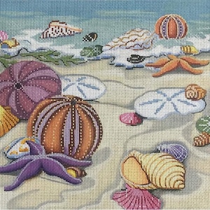 May include: A needlepoint canvas depicting a beach scene with seashells, starfish, sand dollars, and a purple and orange sea urchin. The background is a light blue sky and ocean.