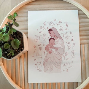 May include: A digital illustration of a woman holding a baby and a lamb. The woman is wearing a white robe and a blue veil. The baby is wearing a white robe. The lamb is white. The background is a light pink with a floral pattern.