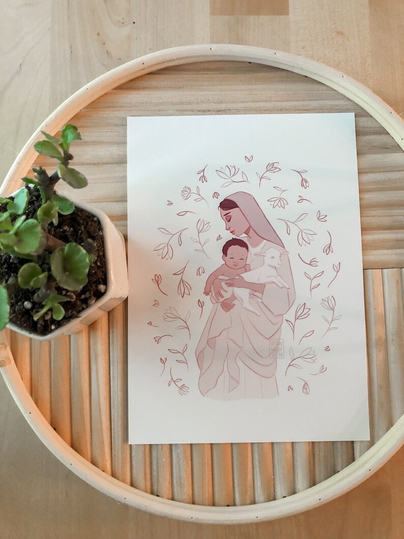 May include: A digital illustration of a woman holding a baby and a lamb. The woman is wearing a white robe and a blue veil. The baby is wearing a white robe. The lamb is white. The background is a light pink with a floral pattern.