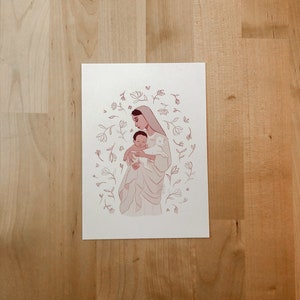 May include: A digital illustration of a woman holding a baby in her arms. The woman is wearing a white dress and a veil. The baby is wearing a white dress. The illustration is surrounded by a circle of pink flowers.