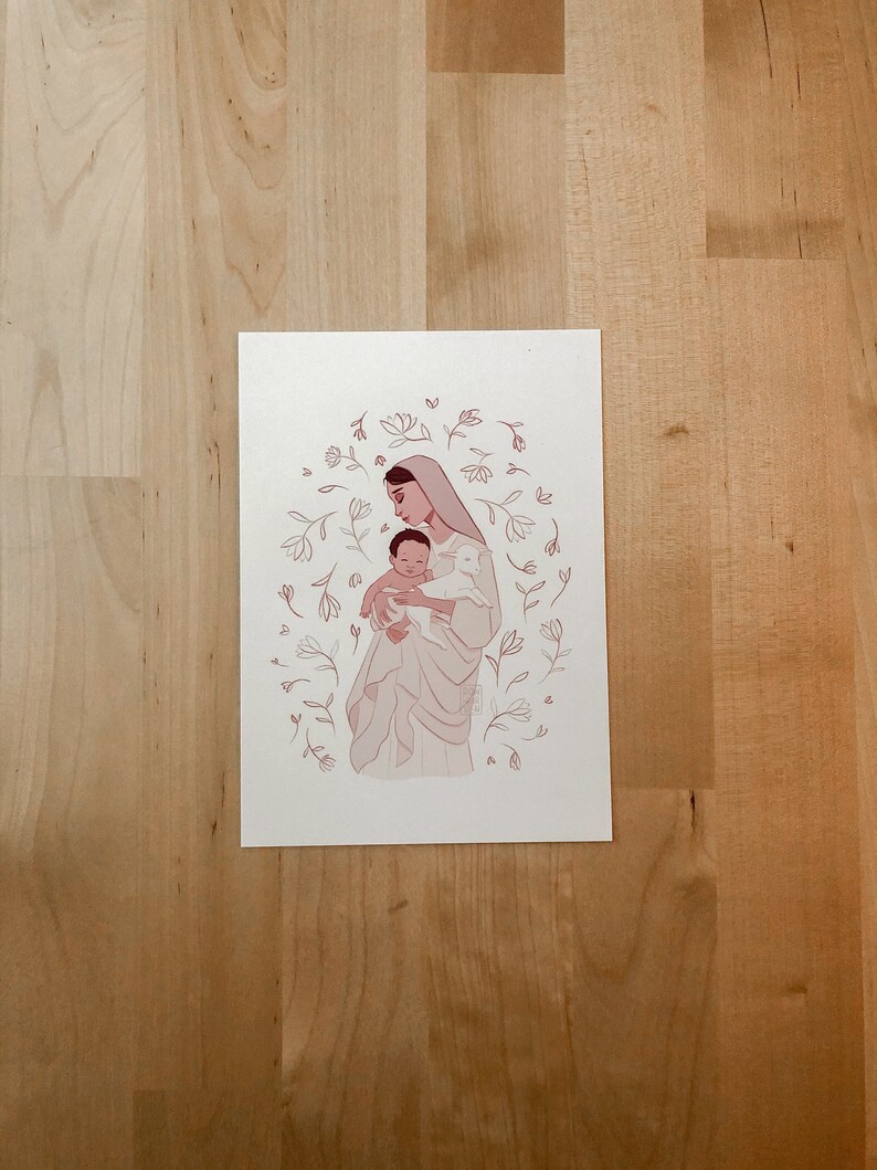 May include: A digital illustration of a woman holding a baby in her arms. The woman is wearing a white dress and a veil. The baby is wearing a white dress. The illustration is surrounded by a circle of pink flowers.