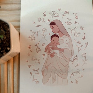 May include: A digital illustration of a woman holding a baby and a lamb. The woman is wearing a white robe and has dark hair. The baby is wearing a white cloth and has dark hair. The lamb is white and has a pink nose. The background is a light pink with a floral pattern.