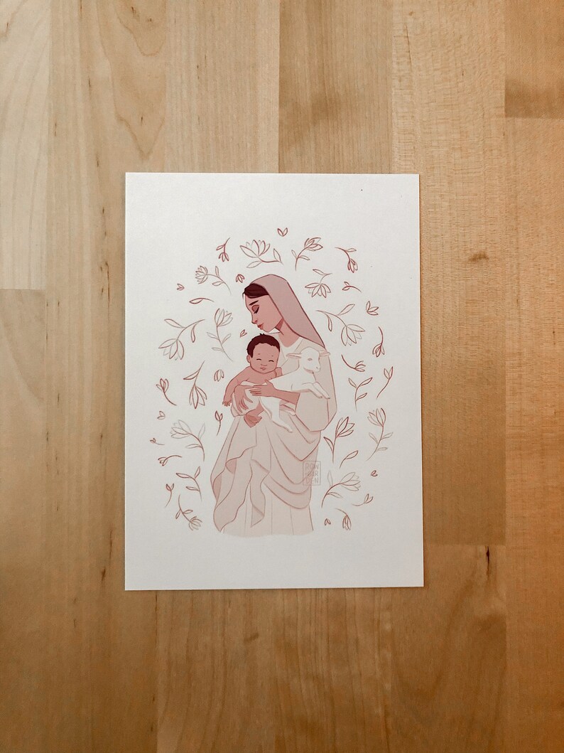 May include: A digital illustration of a woman holding a baby and a lamb. The woman is wearing a white veil and a long white dress. The baby is wearing a white onesie. The lamb is white and has a pink nose. The background is a light pink with white flowers.