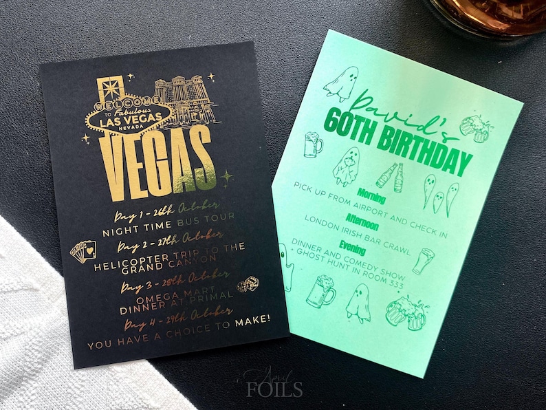 May include: Two event cards. One black card with gold text that says "VEGAS" and details of a trip. The other is a green card with "David's 60th Birthday" and a schedule with ghost and beer illustrations.