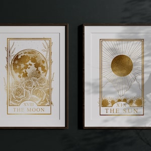 May include: Two framed prints of tarot cards, The Moon and The Sun, with gold foil accents on a white background.