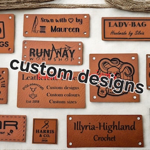 Peut inclure: Une collection d'étiquettes en cuir beige, rectangulaires et carrées, présentant divers logos, noms de marque et textes personnalisés gravés au laser. Chaque étiquette comporte de petits trous pré-percés aux coins pour la fixation.