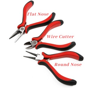 May include: A set of three jewelry making tools with red handles and black grips. The tools include a flat nose plier, a wire cutter, and a round nose plier.