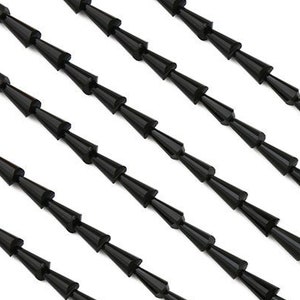 May include: A strand of black, cone-shaped beads. The beads are strung together on a clear thread.