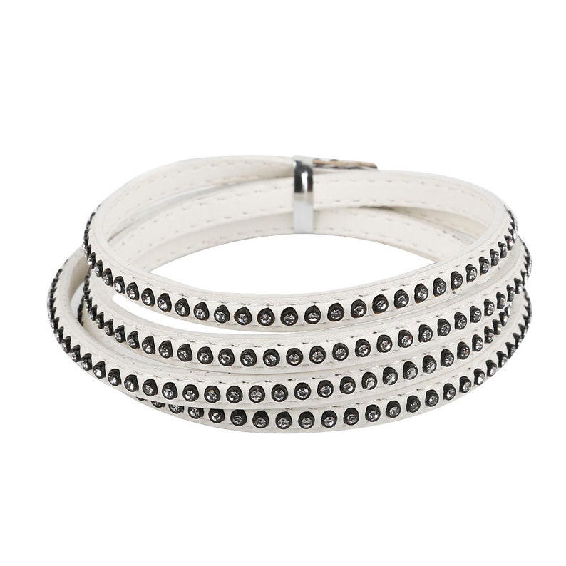 May include: White leather wrap bracelet with a row of small rhinestones on each band.