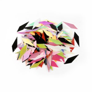 Peut inclure: Un tas de paillettes irisées en forme de diamant de différentes nuances de rose, rouge, jaune, vert et bleu. Il y a aussi quelques paillettes noires dans le tas.