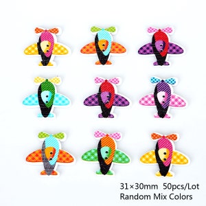 May include: Set of 9 colorful wooden airplane buttons, each measuring 31mm x 30mm. The buttons feature a checkered pattern and a cartoon airplane design.  31x30mm 50pcs/Lot Random Mix Colors