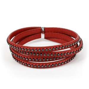 May include: A red leather wrap bracelet with a row of small rhinestones on each layer.