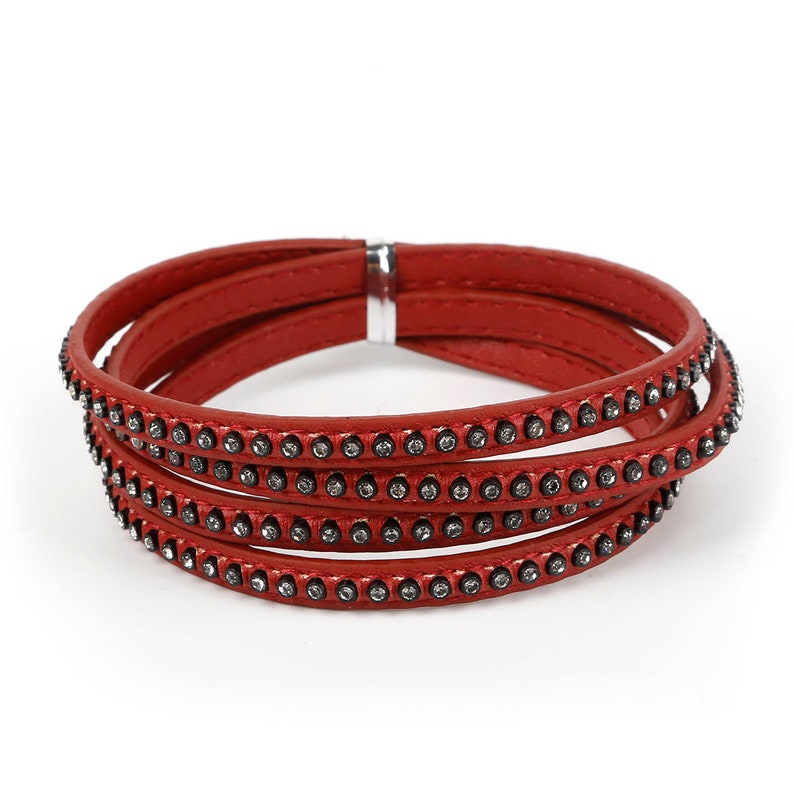 May include: A red leather wrap bracelet with a row of small rhinestones on each layer.