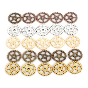 May include: A set of 20 small metal gears in three different colors: gold, silver, and bronze. The gears are arranged in rows, with each row containing a different color.