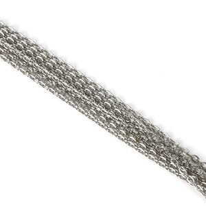 May include: A silver chain necklace with multiple strands of chain links.