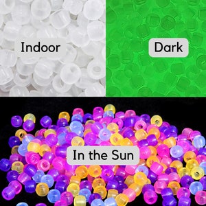 May include: A close-up of a pile of glow-in-the-dark beads. The beads are white indoors, glow green in the dark, and are multi-colored in the sun. The text "Indoor", "Dark", and "In the Sun" is visible in the image.