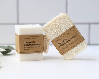 May include: Two zero waste dishwashing products: a white bar soap with a brown label that reads "Juturna Studios Zero Waste Dishwashing Bar Vegan, Natural, Toxic Free 10.9 oz" and a beige loofah sponge with a brown label that reads "Juturna Studios Zero Waste Dishwashing Sponges 5 Pack | Organic | 100% Compostable"