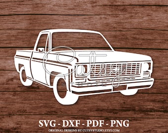 May include: White silhouette of a vintage pickup truck with a grill, headlights, and a bed. The truck is on a woodgrain background.