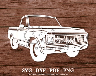 May include: A white silhouette of a vintage pickup truck with a black grille and a Chevrolet logo. The truck is on a woodgrain background.