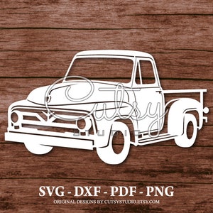 May include: White silhouette of a vintage pickup truck with a flatbed, on a woodgrain background.  SVG - DXF - PDF - PNG. Original designs by CutsyStudio.Etsy.com