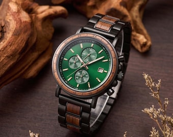 May include: A wristwatch featuring a round green dial with three sub-dials, a date window, and gold-tone hands. The bezel and watch band are constructed from a combination of dark metal and wood links, creating a multi-material aesthetic.