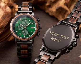 May include: Two wristwatches with black metal and brown wood link bands. One watch features a green analog face with three sub-dials, a date window, and a wood bezel. The other watch shows a solid black back case engraved with the text YOUR TEXT HERE.