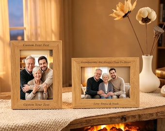May include: Two light-colored wooden picture frames with engraved text. The vertical frame features Custom Your Text at the top and bottom. The horizontal frame displays Grandparents Are Always Close To Heart and Love Emma & Noah.