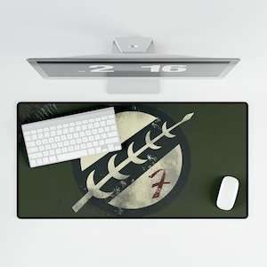 May include: A green and white mousepad with a distressed, circular design featuring a stylized spear and the number "7".
