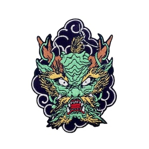 May include: Green and orange embroidered dragon head patch with a black cloud background.