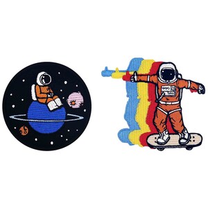 May include: Two embroidered iron-on patches featuring an astronaut. One patch shows an astronaut sitting on a planet in space. The other patch shows an astronaut riding a skateboard.