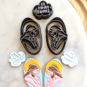 May include: A set of cookie cutters featuring a praying hands design, a cloud with the text "21  DONT  STUM2", and two clouds with the text "Say a Prayer".
