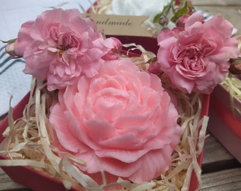 May include: A pink rose soap in a red box with pink roses and the word "Handmade" on a tag. The soap is surrounded by shredded paper.
