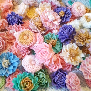 May include: Assortment of colorful handmade soap flowers in various shapes and sizes. The flowers are made to look like roses, daisies, and other floral designs.
