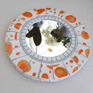 Old china mosaic mirror. Crockery mosaic wall decoration