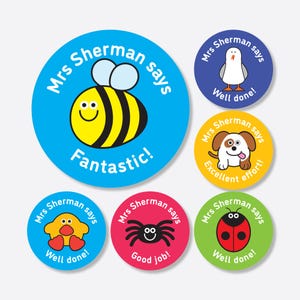 May include: Six colourful round stickers with cartoon animals and the text "Mrs. Sherman says" and a positive message. The stickers feature a bee, a seagull, a puppy, a chick, a spider, and a ladybug.