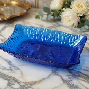 May include: A set of three ceramic nesting bowls in shades of blue, green, and white. The bowls feature a speckled glaze and a simple, modern design. The largest bowl is approximately 7 inches in diameter.